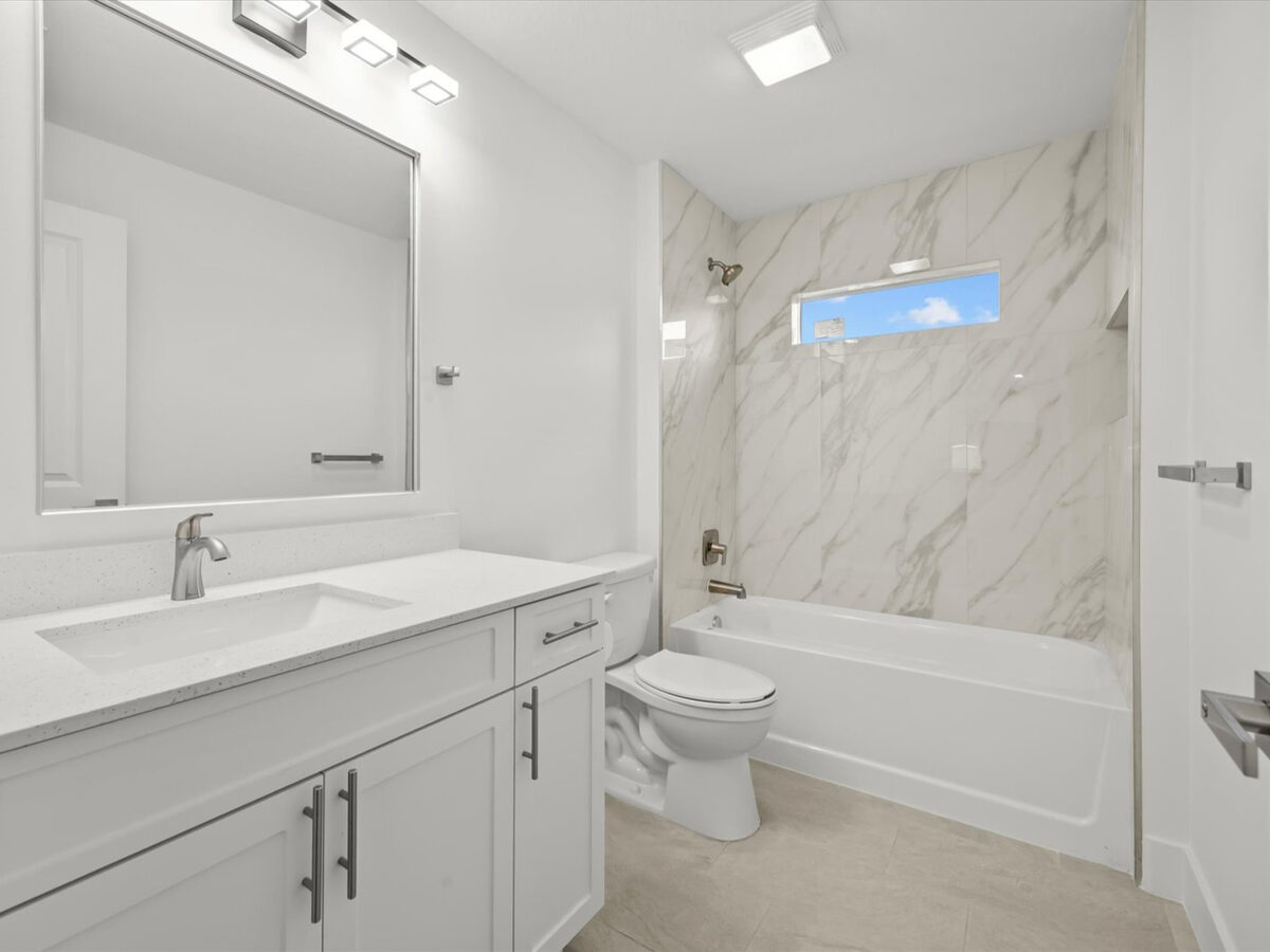 Finished bathroom with modern vanity and fixtures