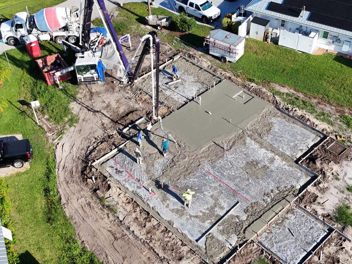 Aerial view of concrete being poured with pump truck