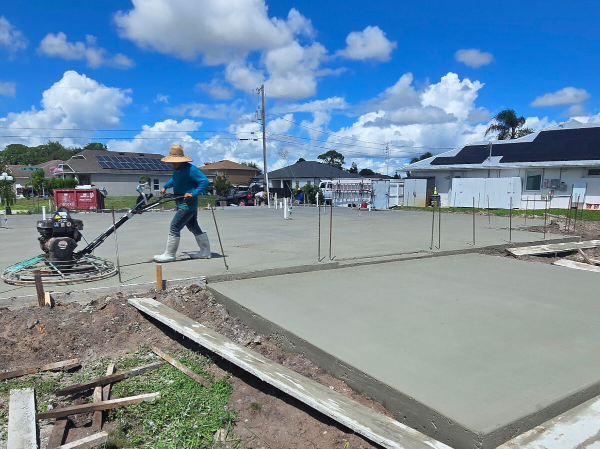 Crew finishing the concrete slab surface