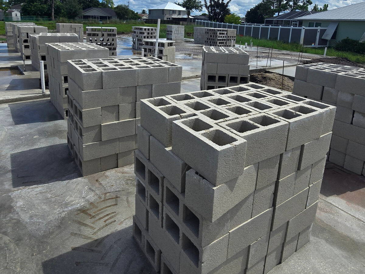 CMU blocks stacked and ready on the slab before wall construction