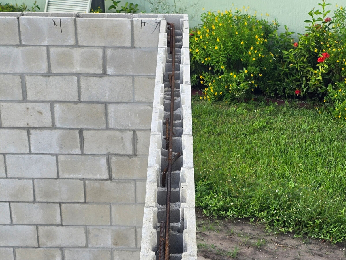 Top view of CMU wall showing rebar placement inside block cells before pour