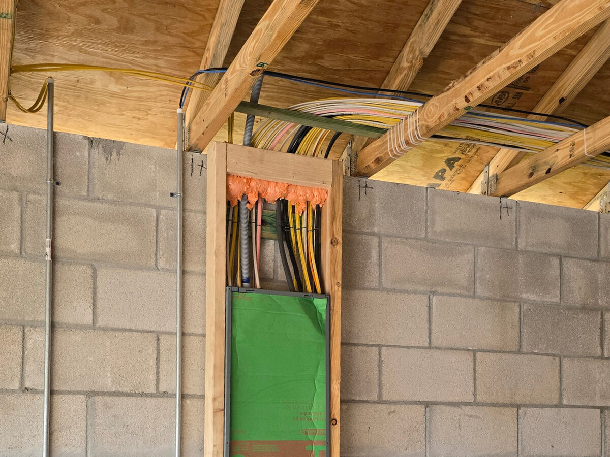 Electrical panel with organized wiring running through trusses