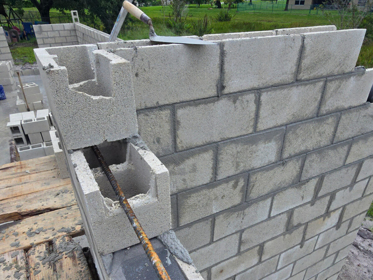 Close-up of CMU block wall construction with rebar visible in cells
