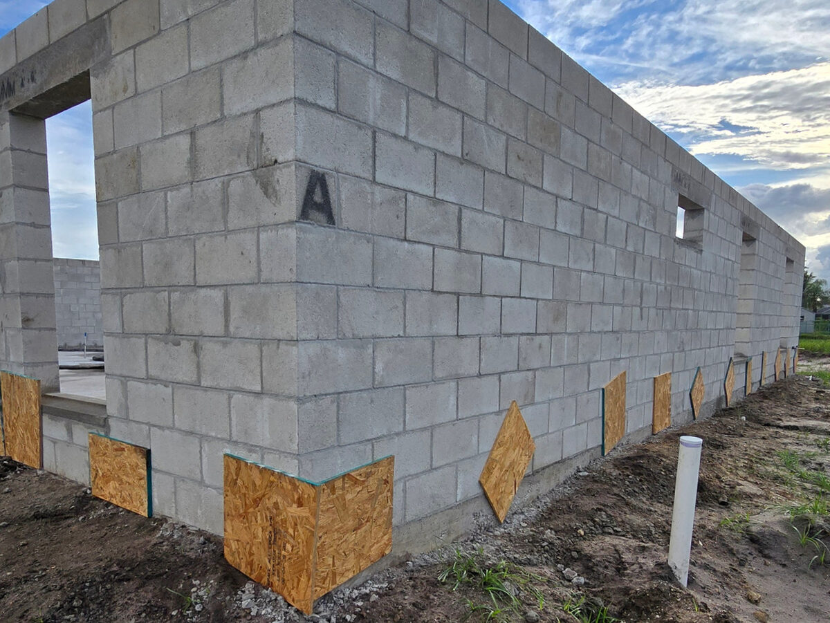 Exterior view of block walls ready for concrete fill with OSB buck covers