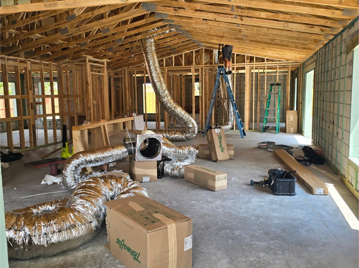HVAC ductwork installed running through ceiling trusses