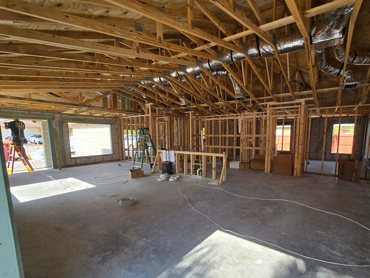 Electrical wiring routed through framing before drywall