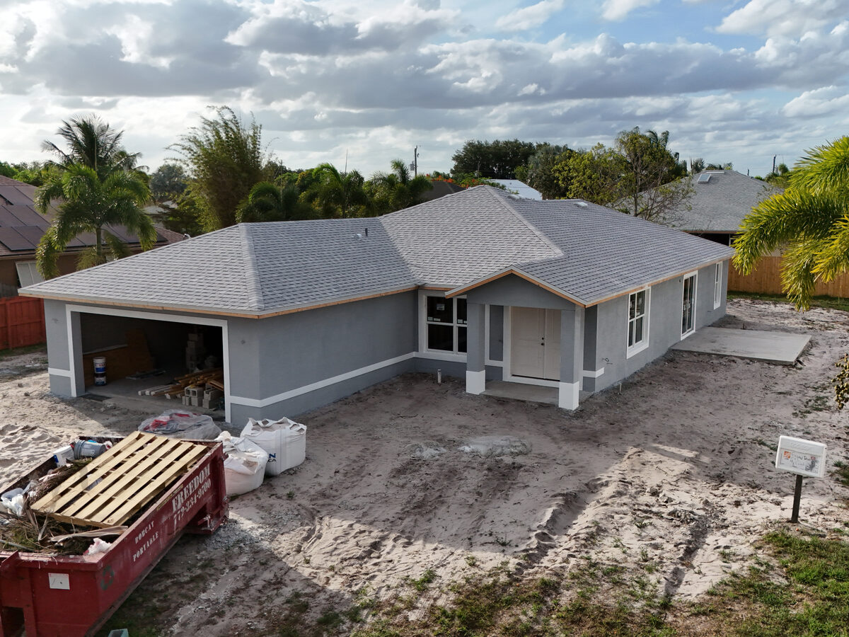 Finished exterior — painted with impact windows and new driveway