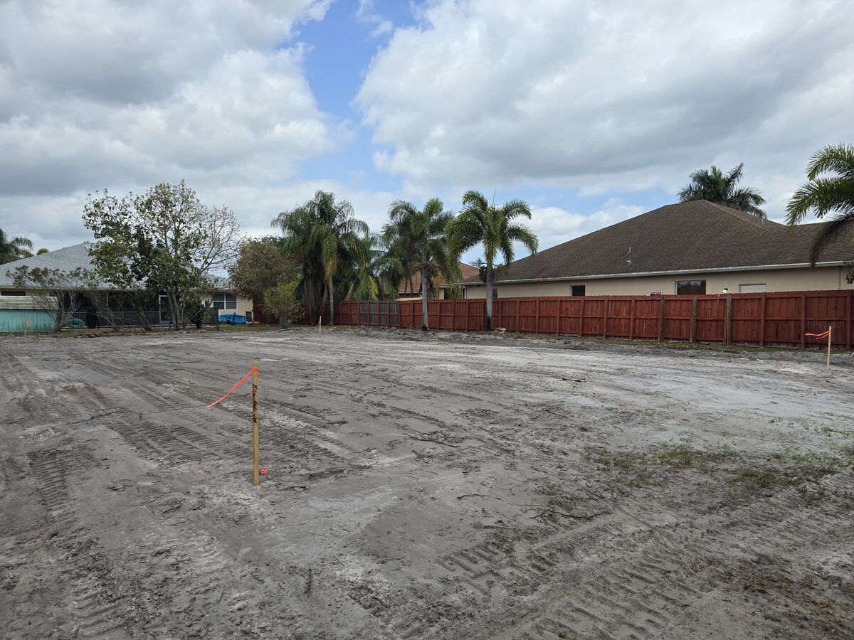 Survey stakes and string lines marking the building footprint