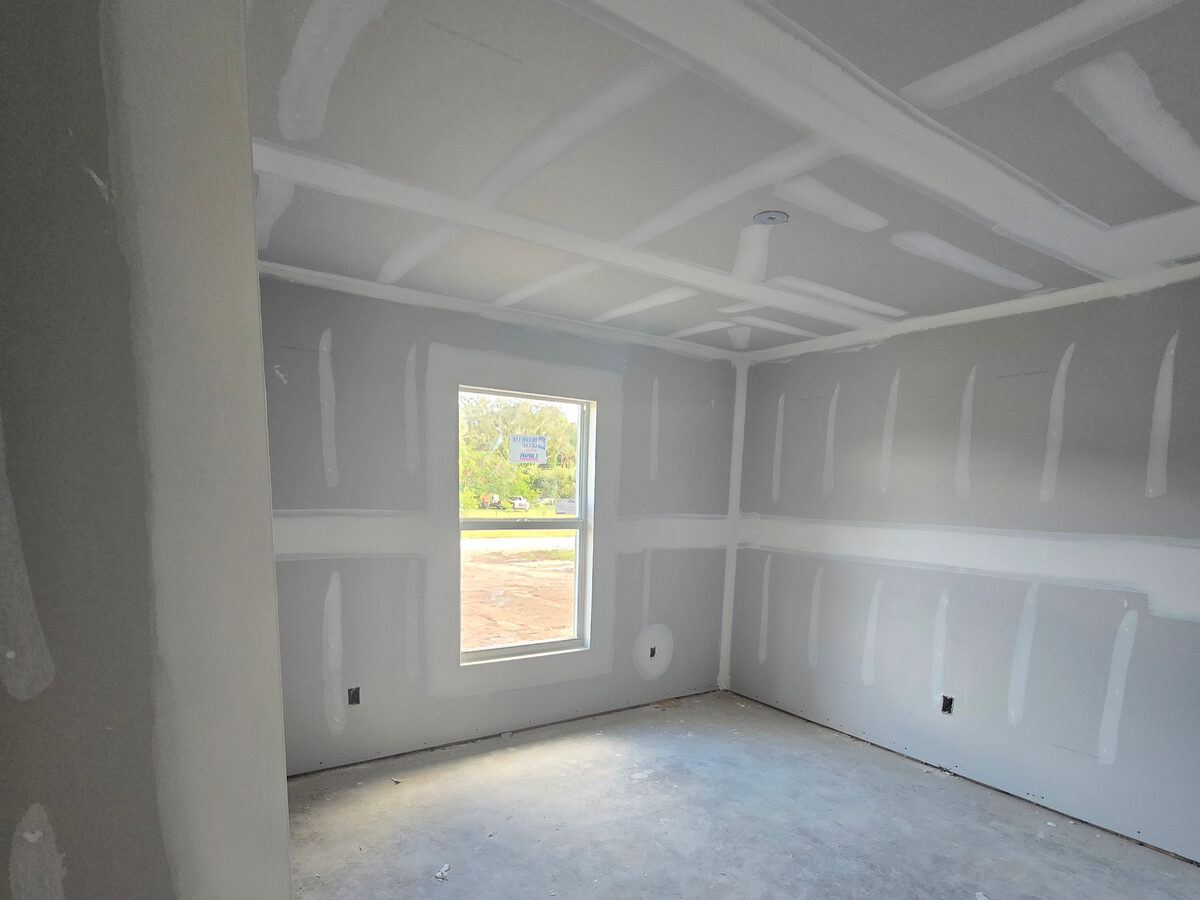 Bedroom with drywall mudded and taped, ready for texture and paint