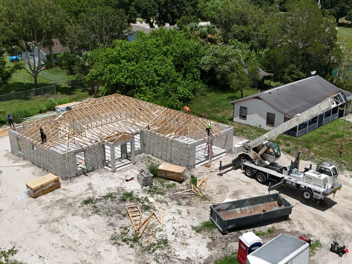 Roof trusses being lifted and set into position by crane