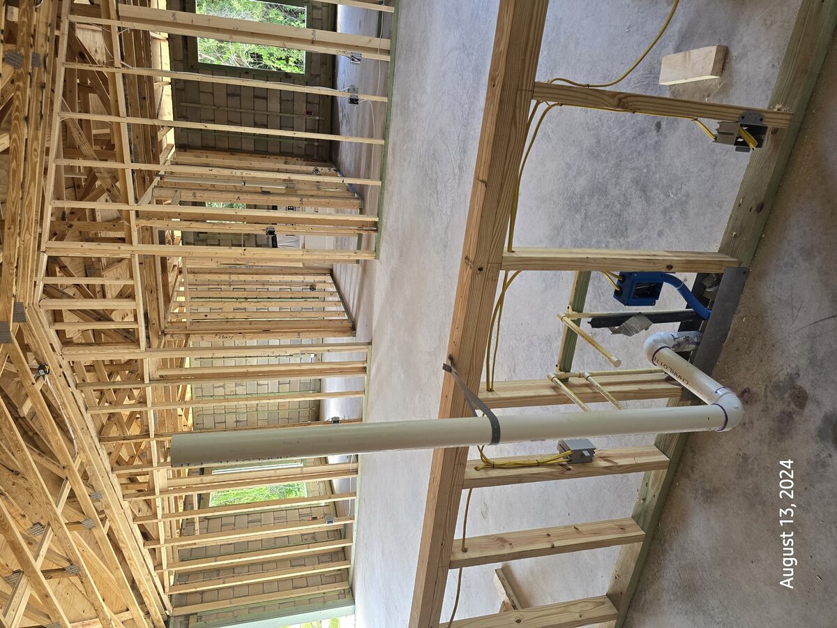 Plumbing rough-in with copper and PVC pipes visible