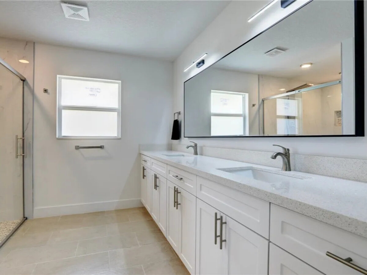 Kitchen with white shaker cabinets, stainless steel appliances, and pot filler