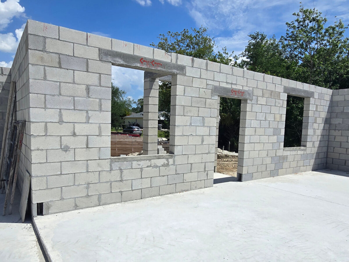 Exterior front view of block walls with door and window openings