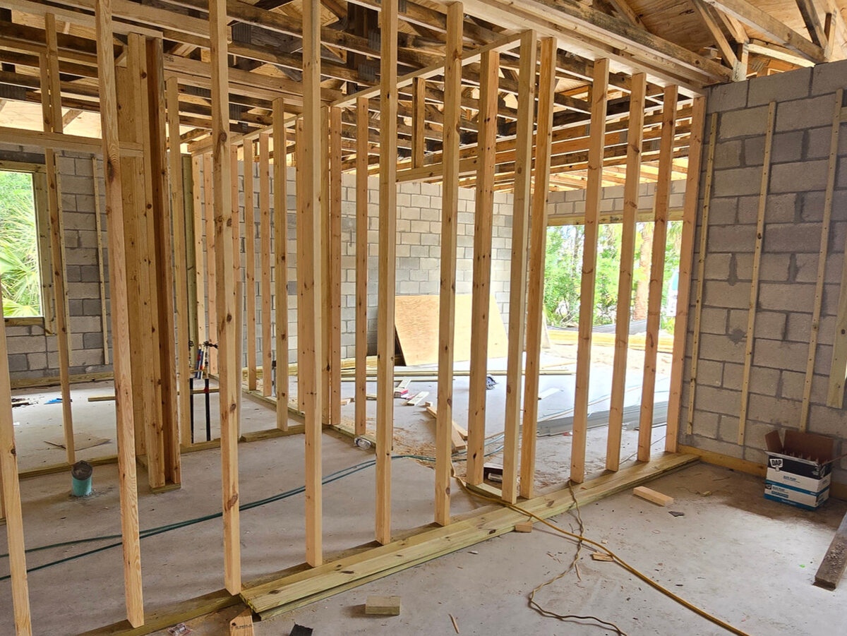Interior wall framing defining room layout with trusses above