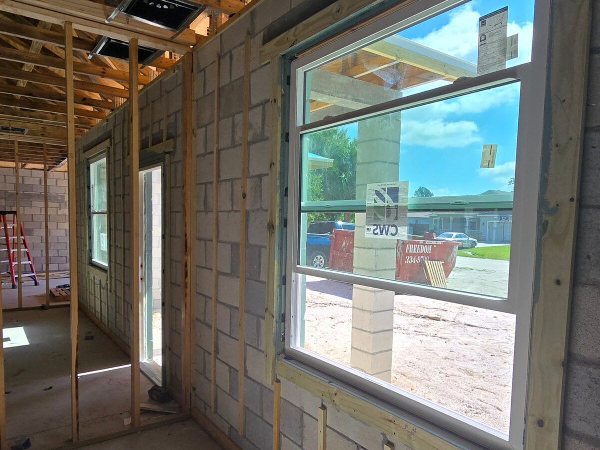 Impact-rated windows installed in block walls with framing visible