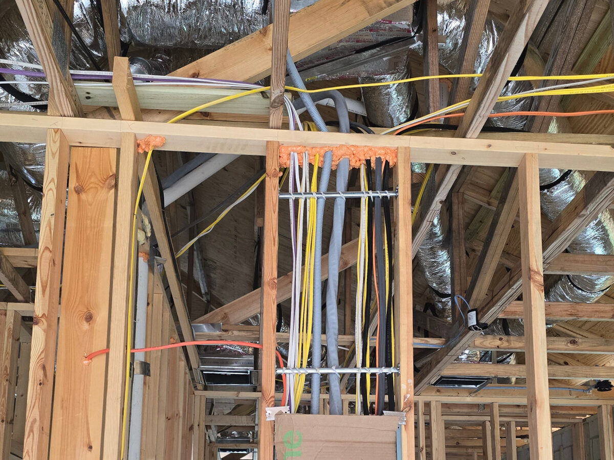 Electrical wiring rough-in with conduits and cables at panel location