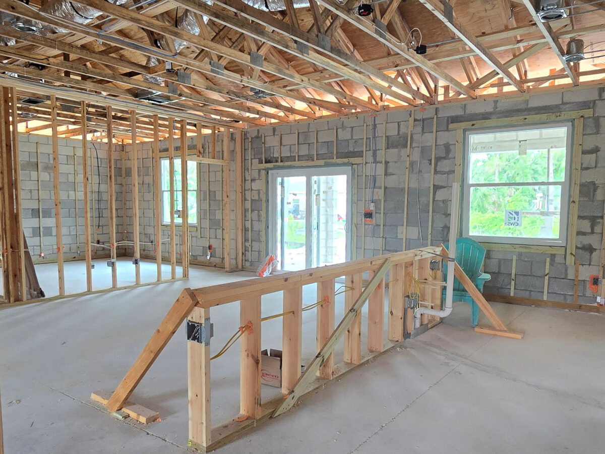 Kitchen island framing with electrical boxes and plumbing stubs