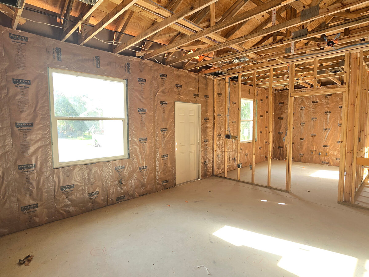Fi-Foil vapor shield insulation installed on framed walls before drywall