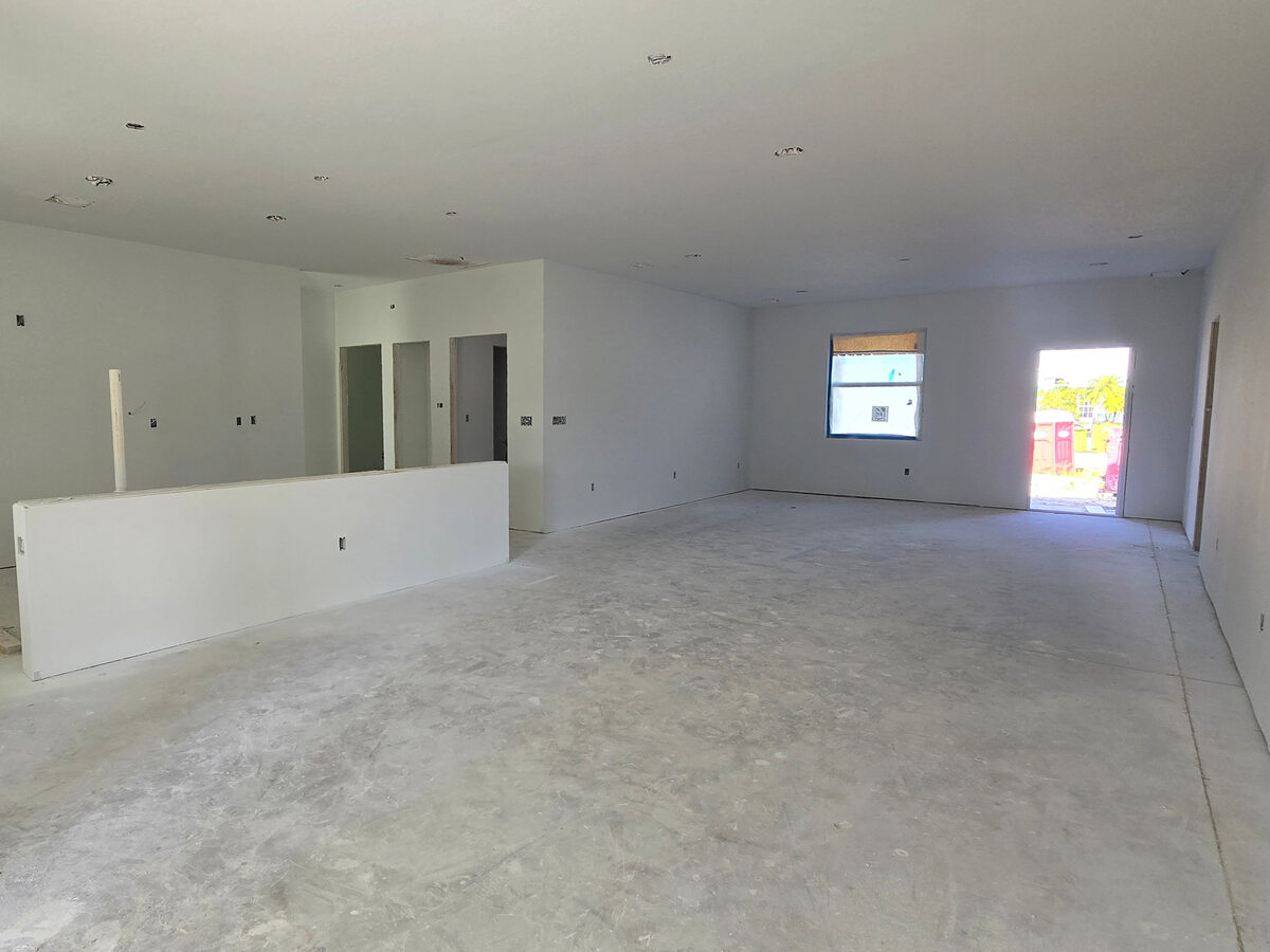 Interior fully painted — open living area with kitchen island half-wall and recessed lighting