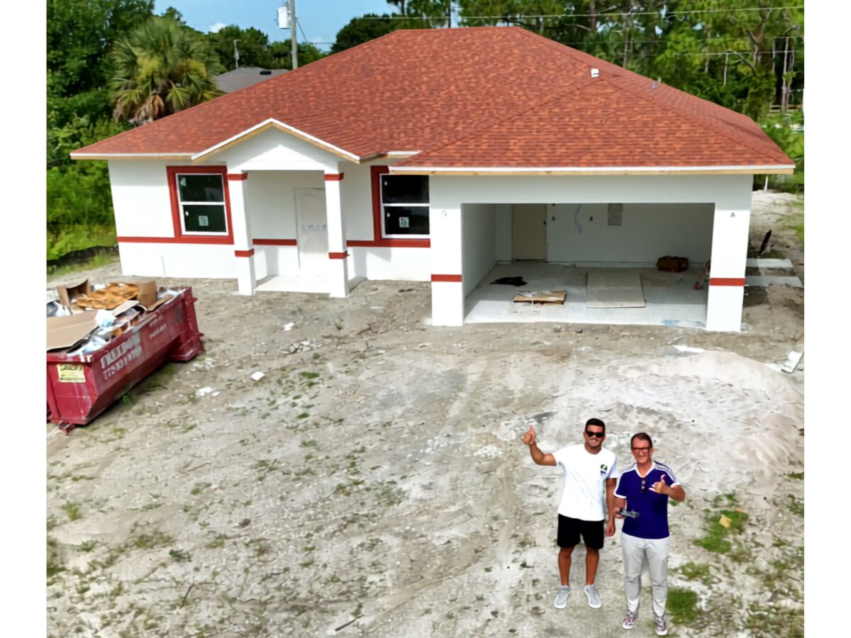 Happy homeowner visiting the job site with Matías — drone shot with freshly painted home behind