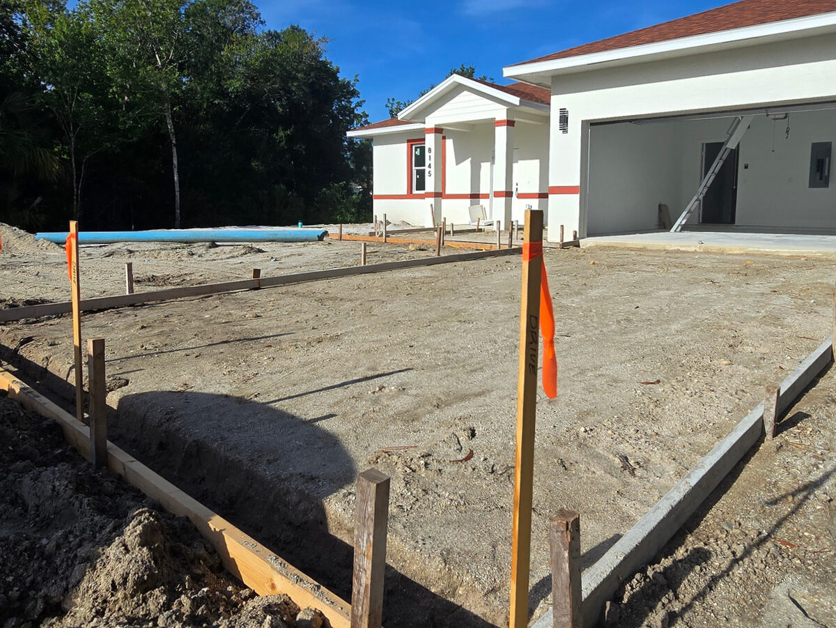 Freshly painted exterior with formboards set for driveway pour