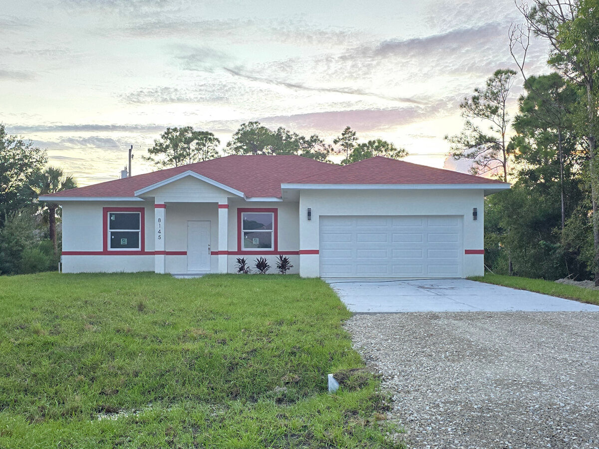 Completed home at twilight — full front view with green sod, driveway, garage and landscaping