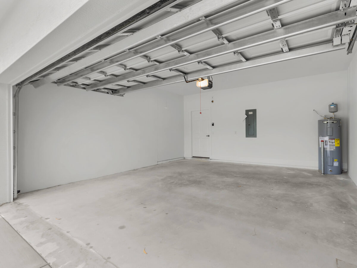 Two-car garage interior with automatic opener, water heater and electrical panel